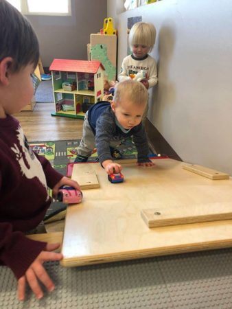2-year-old-boys_playing_with_cars_at_cadence_academy_preschool_broomfield_co-338x450