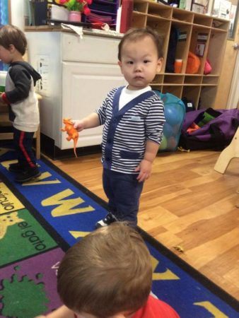 2-year-old_boy_holding_dinosaur_cadence_academy_preschool_east_greenwich_ri-338x450