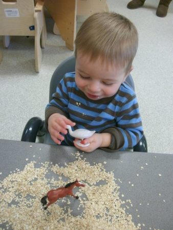 2-year-old_boy_holding_duck_toy_cadence_academy_preschool_ankeny_ia-338x450