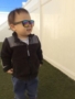 2-year-old_boy_in_sunglasses_on_the_playground_cadence_academy_preschool_east_greenwich_ri-338x450