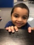 2-year-old_boy_looking_over_edge_of_desk_jonis_child_care_and_preschool_hartford_ct-337x450