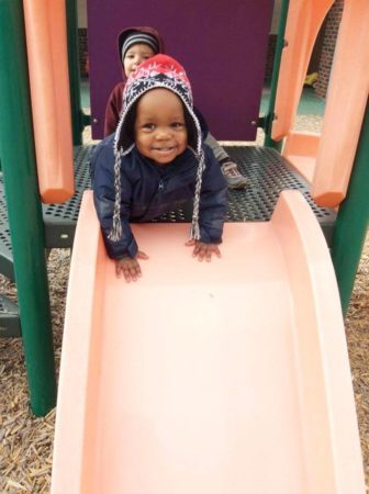 2-year-old_boy_on_slide_cadence_academy_eastfield_huntersville_nc-336x450