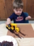 2-year-old_boy_painting_with_construction_toy_cadence_academy_preschool_urbandale_ia-333x450
