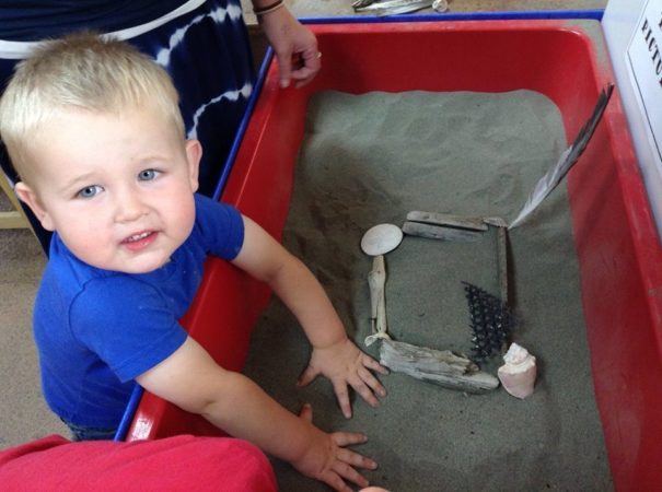2-year-old_boy_playing_with_sand_cadence_academy_preschool_sleater-kinney_olympia_wa-605x450