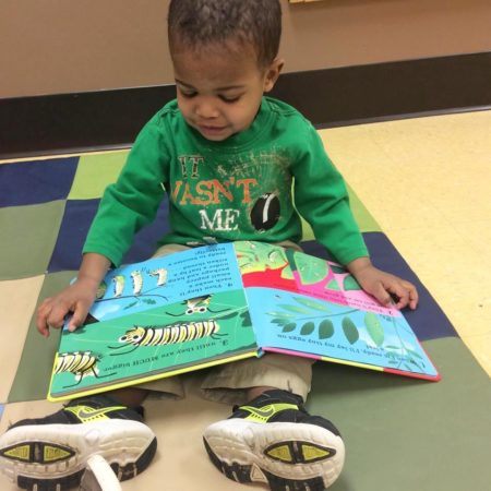 2-year-old_boy_reading_caterpillar_book_creative_expressions_learning_center_eureka_mo-450x450