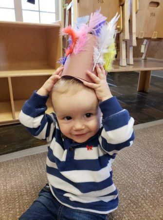 2-year-old_boy_with_feather_hat_cadence_academy_preschool_childrens_center_klamath_falls_or-335x450