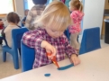 2-year-old_cutting_playdough_cadence_academy_preschool_main_street_normal_il-603x450