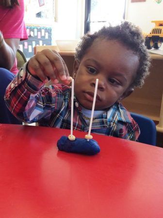 2-year-old_doing_cheerio_activity_at_cadence_academy_preschool_northeast_columbia_sc-336x450