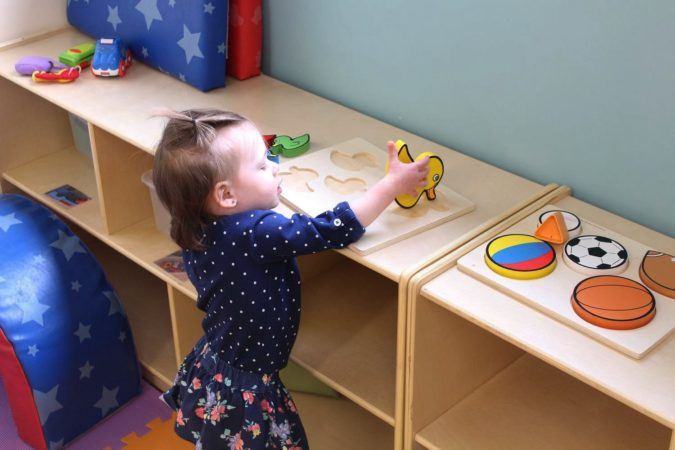 2-year-old_girl_doing_duck_puzzle_cadence_academy_preschool_lincoln_ri-675x450