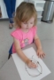 2-year-old_girl_drawing_face_cadence_academy_preschool_johnston_ia-305x450