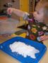 2-year-old_girl_enjoying_glitter_art_project_cadence_academy_preschool_sherwood_or-338x450