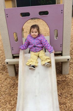 2-year-old_girl_on_slide_cadence_academy_preschool_myrtle_beach_sc-299x450