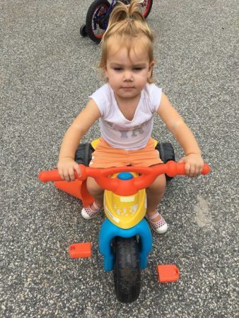 2-year-old_girl_on_tricycle_jonis_child_care_preschool_canton_ct-338x450