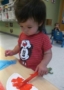 2-year-old_girl_painting_a_pumpkin_cadence_academy_preschool_johnston_ia-318x450