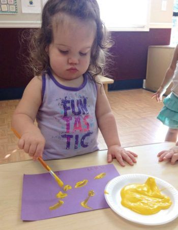 2-year-old_girl_painting_with_yellow_paint_stonebridge_academy_bremen_ga-350x450