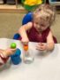 2-year-old_girl_playing_with_eye_dropper_cadence_academy_preschool_sellwood_portland_or-338x450