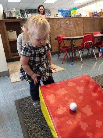 2-year-old_girl_rolling_ball_down_ramp_jonis_child_care_preschool_canton_ct-338x450