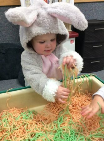 2-year-old_in_costume_playing_with_yarn_next_generation_childrens_centers_hopkinton_ma-333x450