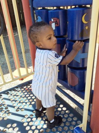 2-year-old_on_playground_equipment_cadence_academy_preschool_mallard_charlotte_nc-336x450