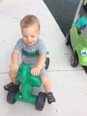 2-year-old_on_scooter_outside_cadence_academy_preschool_austin_cedar_park_tx-336x450