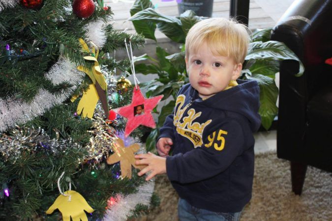2-year-old_putting_ornaments_on_christmas-tree_at_cadence_academy_preschool_lexington_sc-675x450