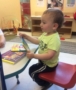 2-year-old_reading_book-at_cadence_academy_preschool_bourne_ma-378x450