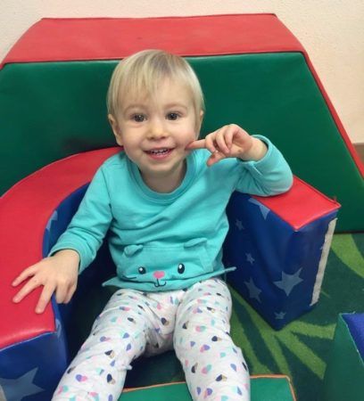 2-year-old_relaxing_on_foam_pieces_cadence_academy_preschool_milwaukie_portland_or-408x450