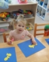 2-year-old_with_pigtails_doing_fish_art_cadence_academy_preschool_clive_ia-353x450