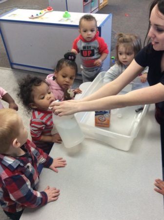 2-year-olds_doing_science_experiment_with_vinegar_and_baking_soda_rogys_learning_place_lake_street_peoria_heights_il-336x450