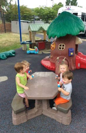 2-year-olds_eating_bomb_pops_on_playground_creative_expressions_learning_center_eureka_mo-293x450