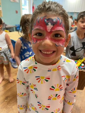 A child with facepaint indoors