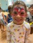 A child with facepaint indoors