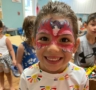 A child with facepaint indoors