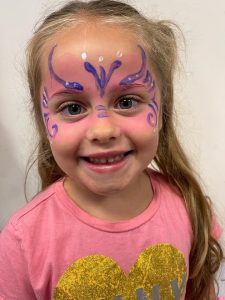 A child with facepaint indoors