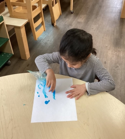 boy with blue paint making art at cadence academy preschool and daycare in dupont washington