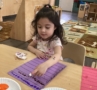 young girl playing with paint to learn numbers at cadence academy preschool and daycare in dupont washington