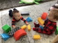 infants playing together with blocks on the floor at cadence academy preschool and daycare in dupont washington