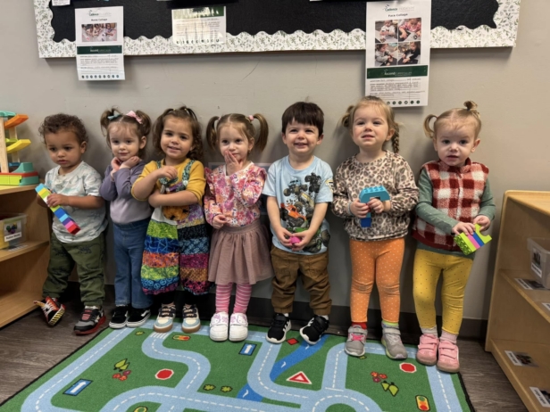 children smiling in a line in a classroom at preschool and daycare cadence academy preschool 502 spring hill