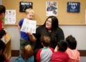Teacher leading a group learning activity with children at Craycroft