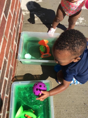 child learning outside with toys at cadence academy preschool and daycare raintree in huntersville north carolina