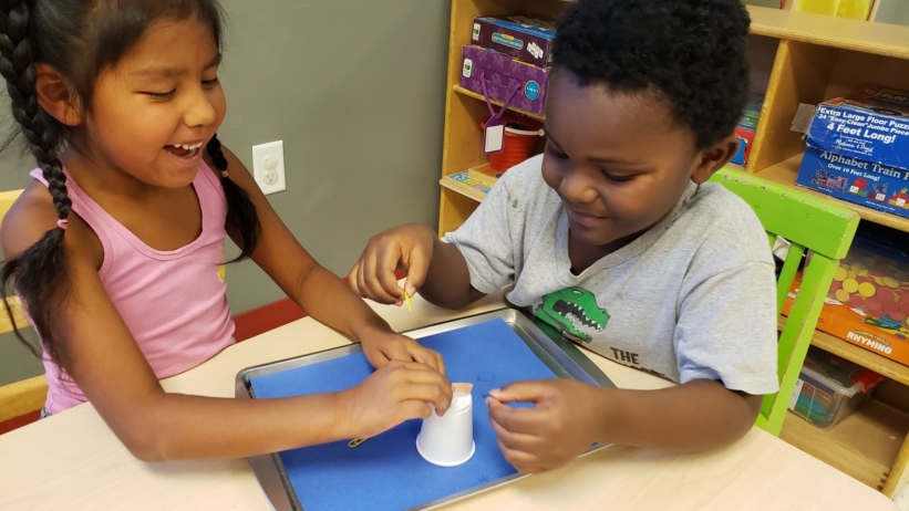 children completing a hands-on activity at Craycroft