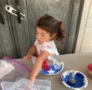 child making fourth of july craft with paint and glue at cadence academy preschool and daycare in dupont washington