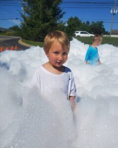 children playing in foam