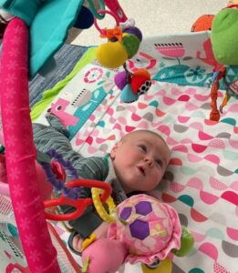 infant playing on tummy
