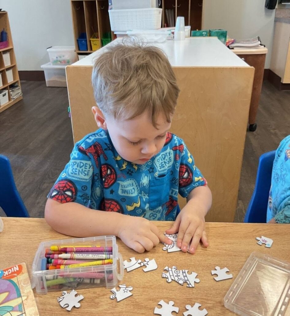 child playing with puzzle