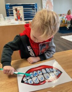 child learning how to brush teeth