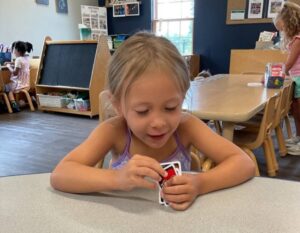 CHild holding uno cards
