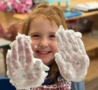 Child holding up dirty hands at Crestwood
