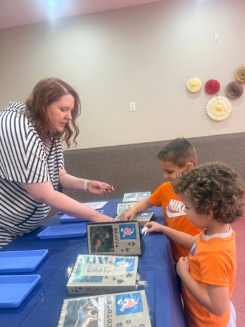 Children looking at something from the teacher at Crestwood