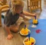 Child using unique sponges to paint at Crestwood
